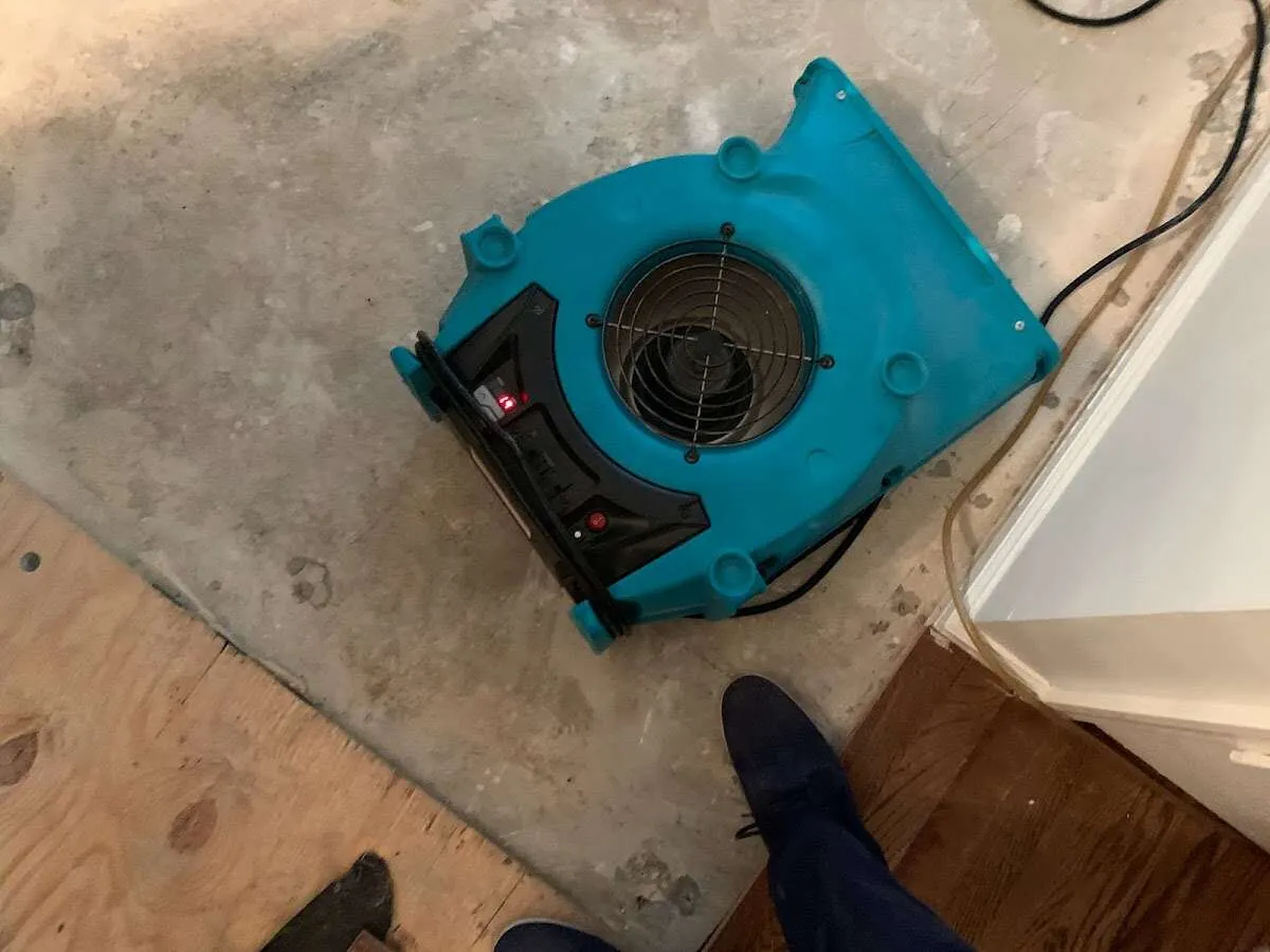 Air mover drying subfloor during Leak Detection & Repair in Penn